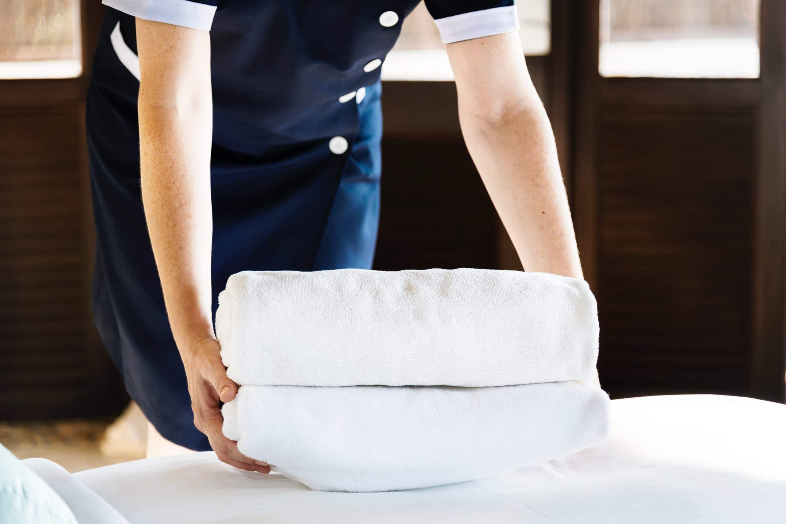 housekeeping hotel employee with bath towels